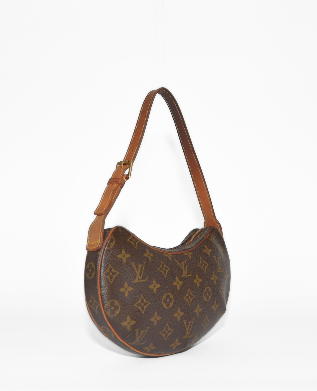 Vintage luxury Louis Vuitton Croissant PM shoulder bag with authentic monogram canvas and tan leather trim. - Louis Vuitton Croissant PM Canvas Shoulder Bag