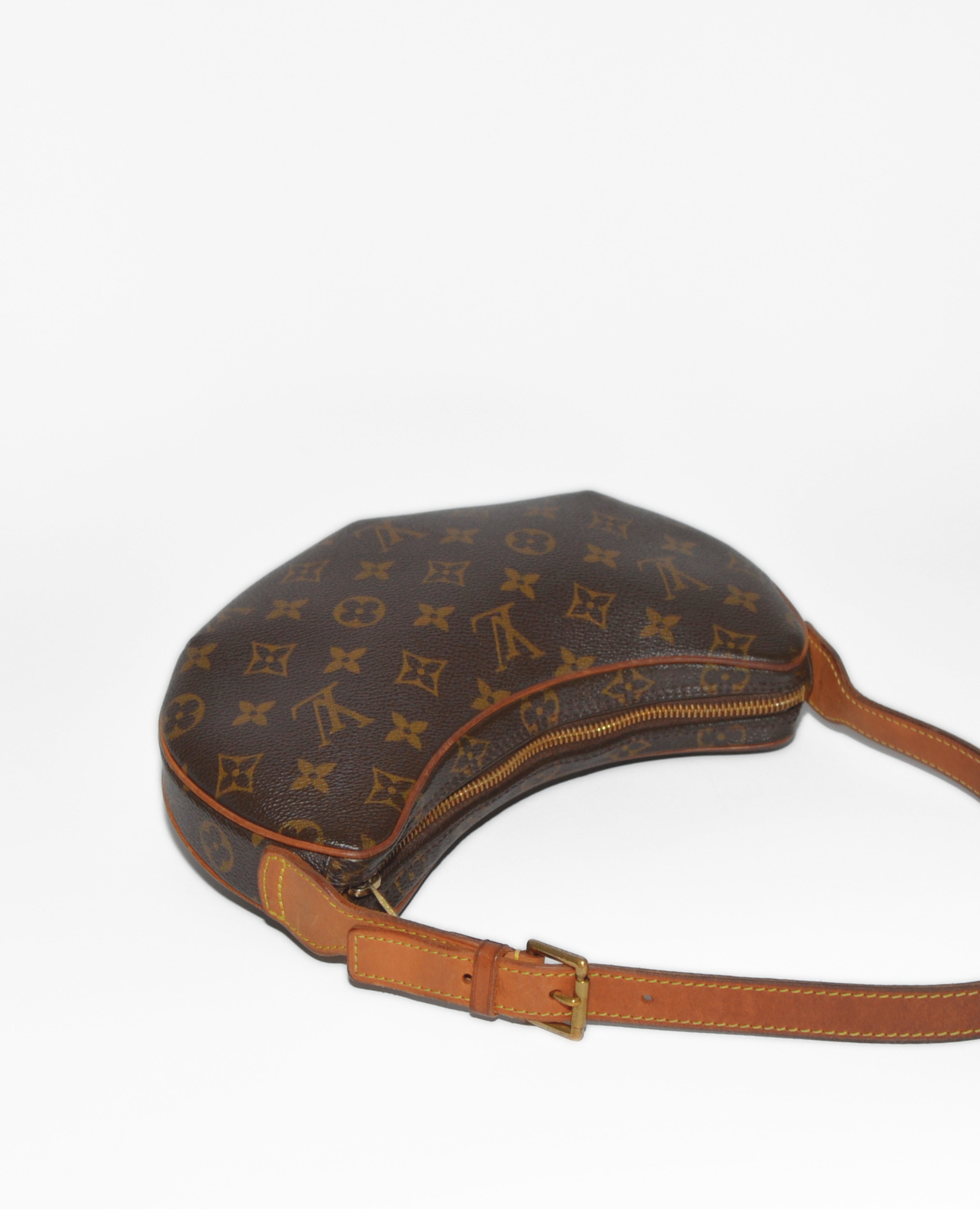 Louis Vuitton Croissant PM shoulder bag in vintage luxury monogram canvas with tan leather trim and adjustable strap. - Louis Vuitton Croissant PM Canvas Shoulder Bag