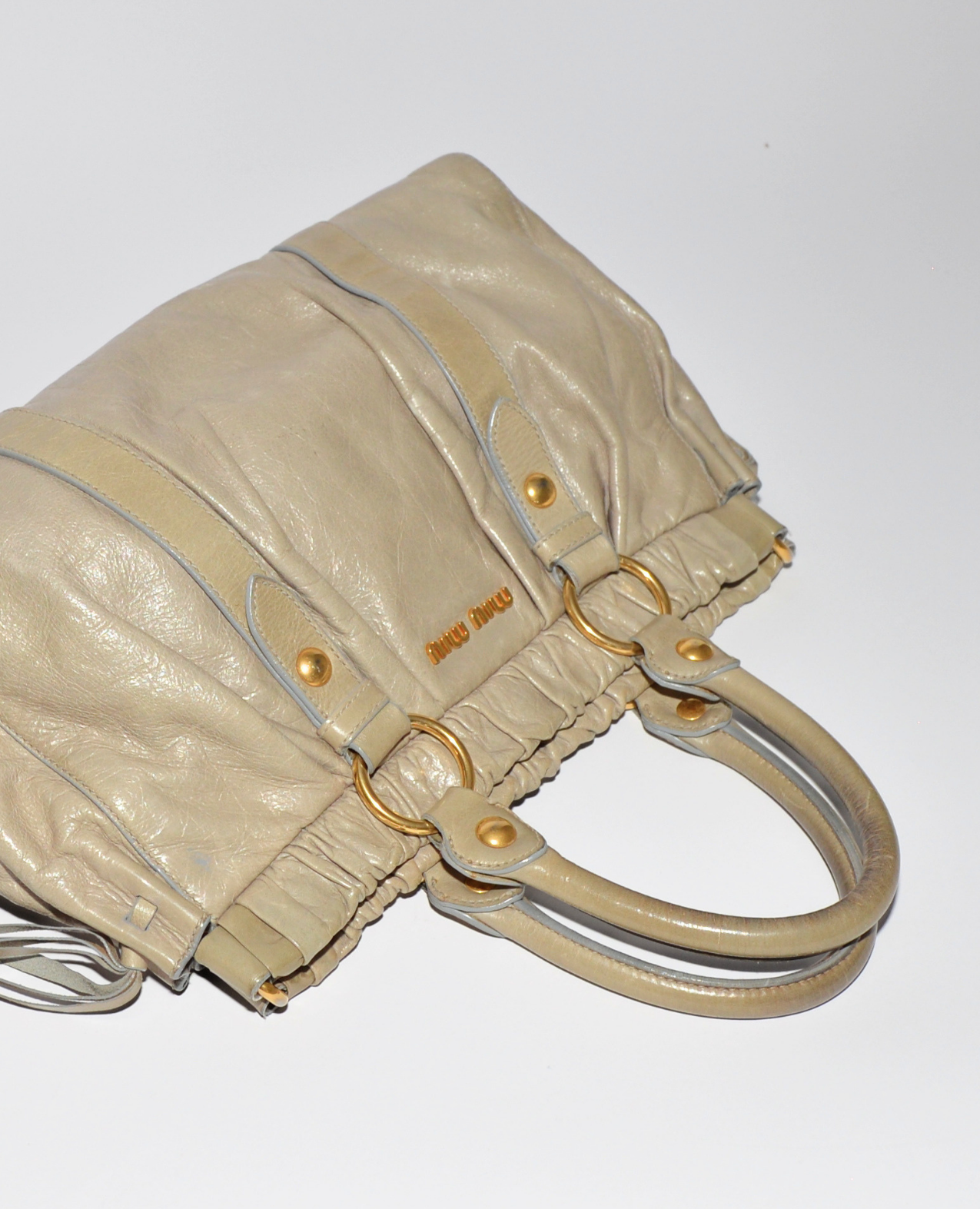 Beige vintage luxury Miu Miu Vitello leather handbag with gold-tone hardware and subtle monogram detail, designer high-end. - Miu Miu Vitello Leather Handbag