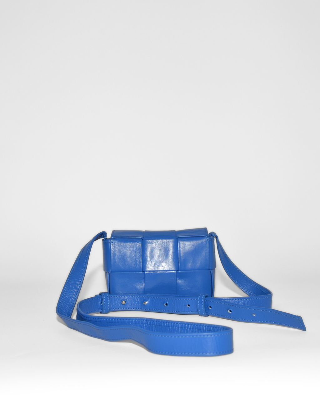 Blue leather Bottega Veneta Mini Casette crossbody bag with woven monogram design, high-end vintage luxury accessory. - Bottega Veneta Mini Casette Crossbody Bag